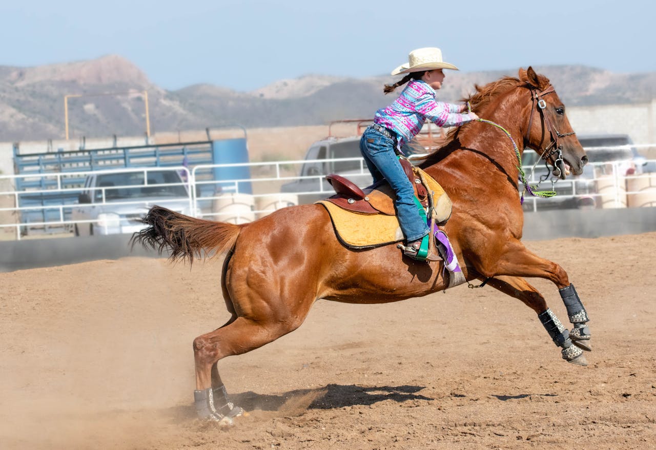 A teenage girl riding a horse in a dynamic rodeo scene, showcasing rural equestrian skills.
